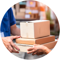 Two people exchanging delivery boxes outdoors