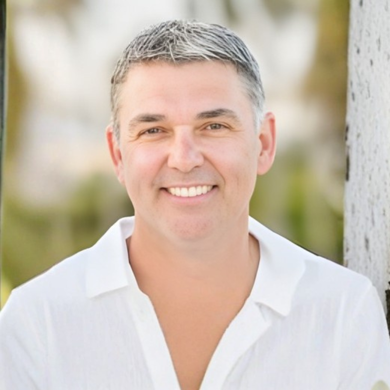 Smiling person in white shirt outdoors