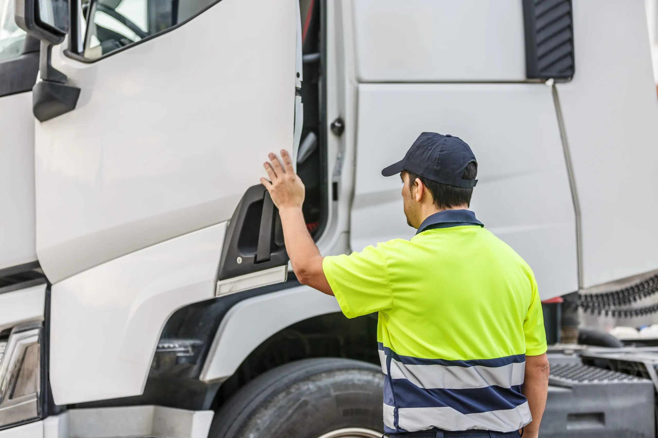 Truck driver opening vehicle door